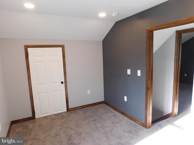 additional living space with light carpet and lofted ceiling