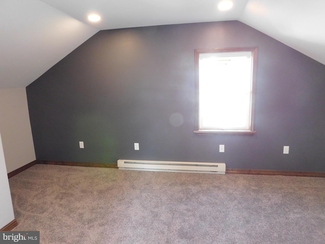 additional living space with baseboard heating, carpet floors, and lofted ceiling