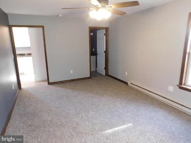 unfurnished room with plenty of natural light, light colored carpet, and a baseboard radiator