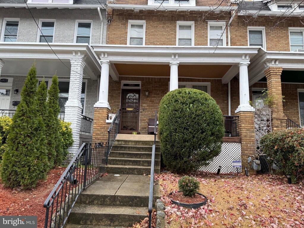 4524 4th St NW, Washington, DC 20011 - view of front of home featuring brick siding, mansard roof, and covered porch