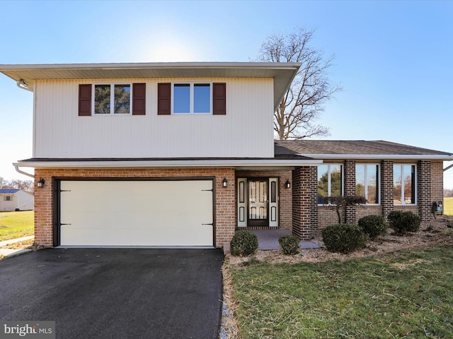 view of front of property featuring a garage and a front lawn