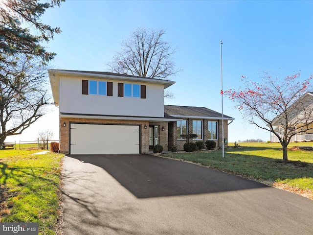 view of front facade with a front yard and a garage