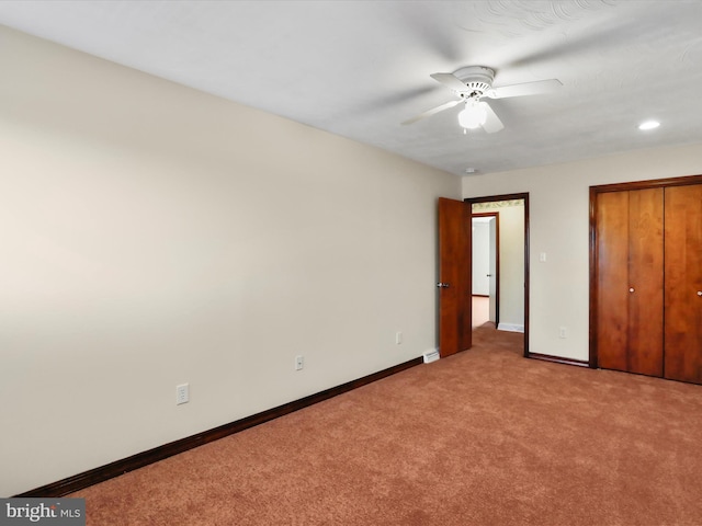 unfurnished bedroom featuring ceiling fan and light colored carpet