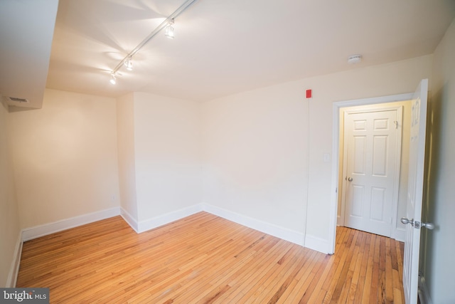 unfurnished room featuring light hardwood / wood-style floors and track lighting