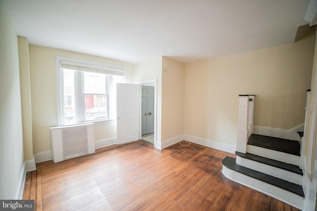 interior space with wood-type flooring and radiator