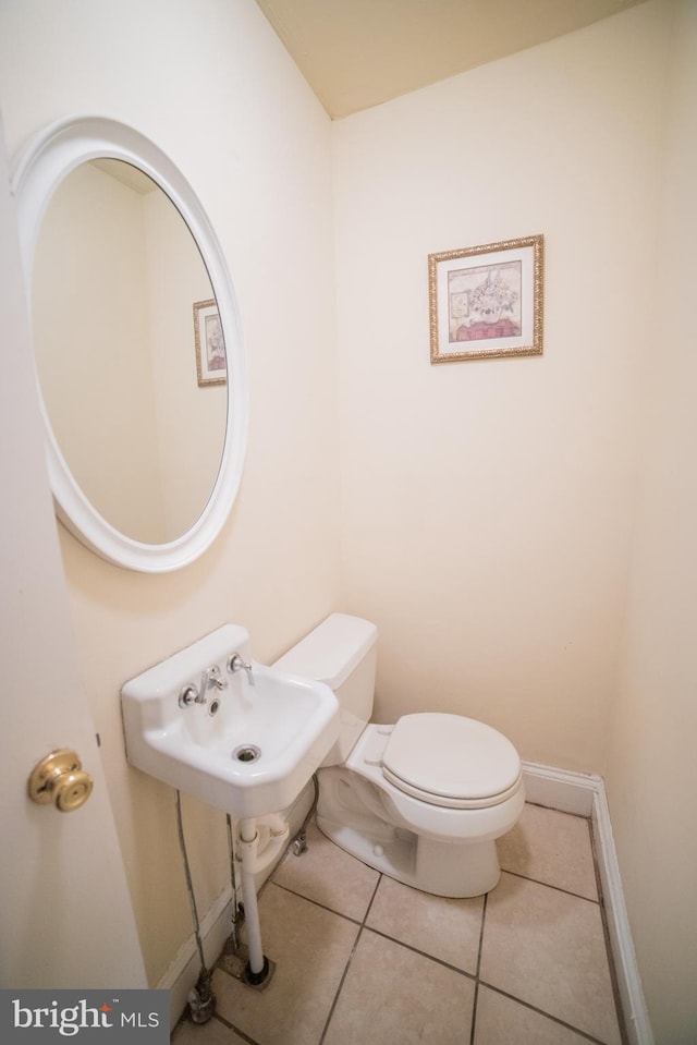 bathroom with tile patterned flooring and toilet