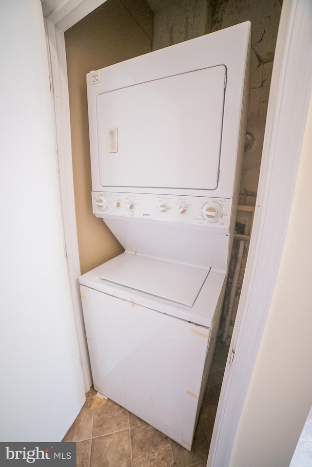 laundry room featuring stacked washer and clothes dryer