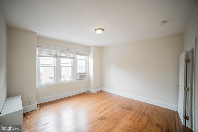 empty room with hardwood / wood-style floors and cooling unit