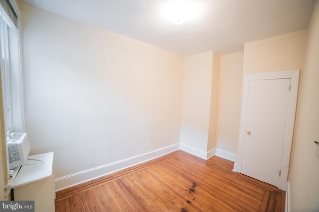 empty room with hardwood / wood-style flooring