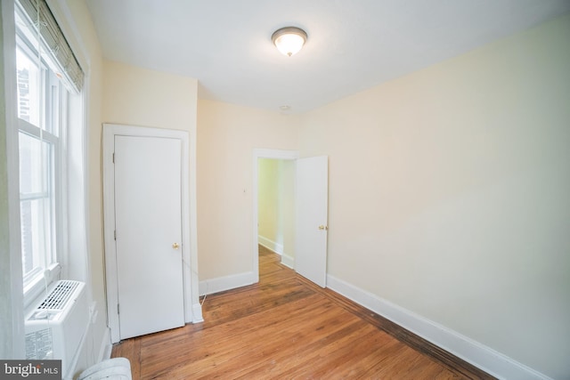 unfurnished bedroom featuring light wood-type flooring and multiple windows