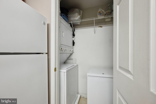 clothes washing area with stacked washer / drying machine