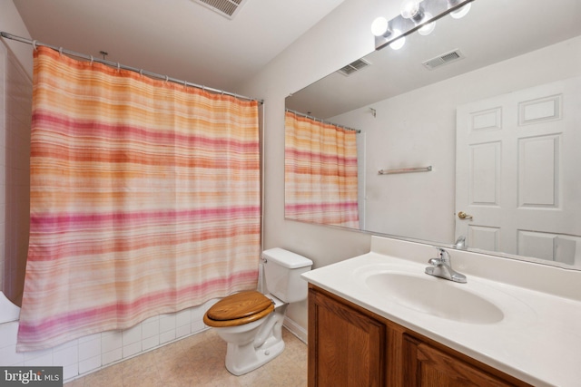 full bathroom featuring vanity, shower / tub combo, and toilet