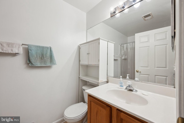 bathroom featuring vanity, toilet, and a shower with shower curtain