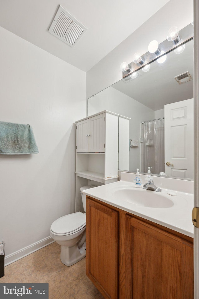 bathroom featuring vanity, tile patterned flooring, curtained shower, and toilet