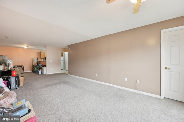 interior space featuring carpet floors and ceiling fan