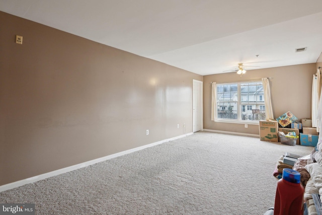 unfurnished living room featuring ceiling fan and carpet