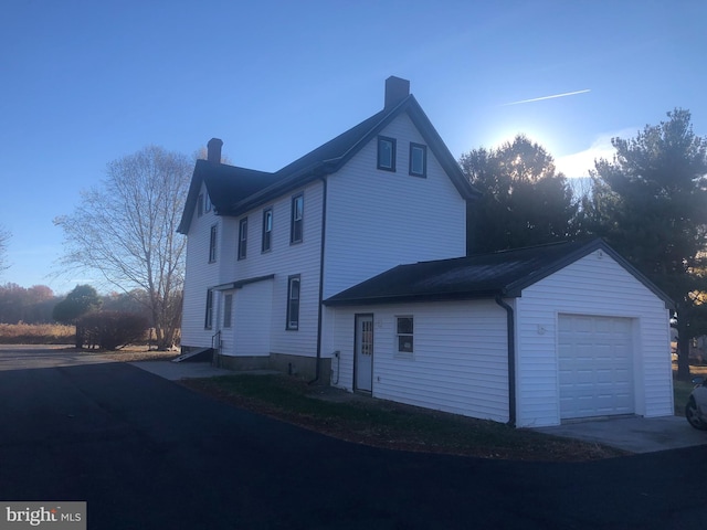 view of side of home featuring a garage