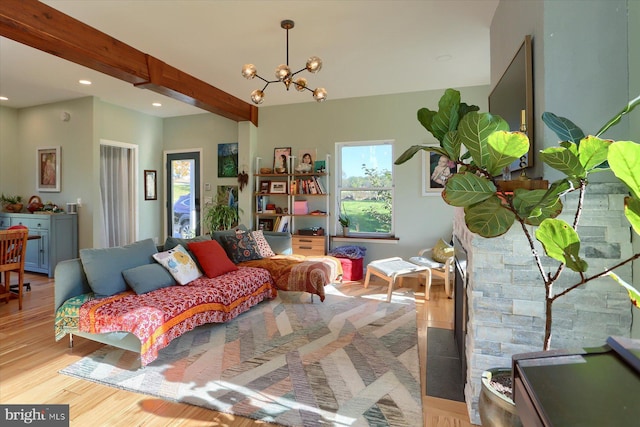 bedroom with light wood-style floors, recessed lighting, beam ceiling, and a chandelier