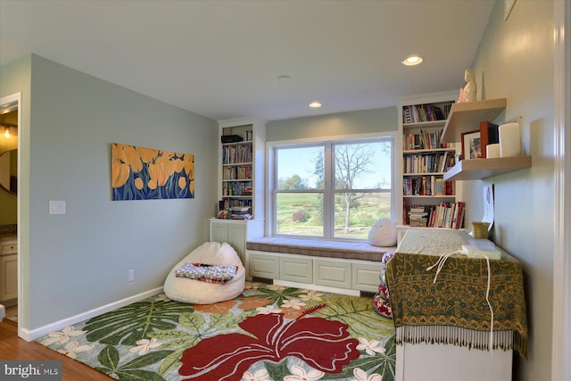 sitting room with light wood-type flooring, baseboards, and recessed lighting