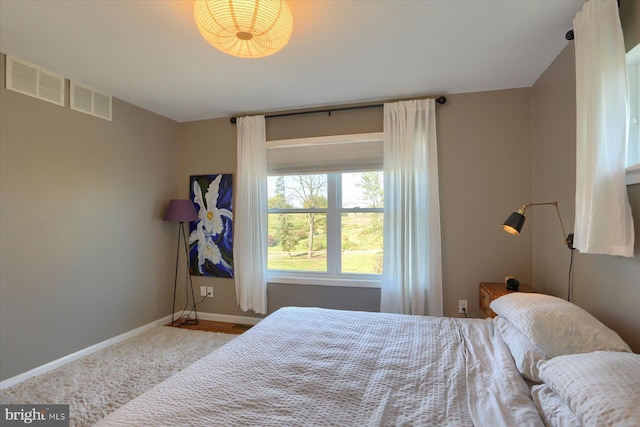 bedroom with visible vents and baseboards