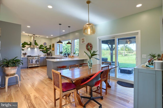 dining space with light wood-type flooring and recessed lighting