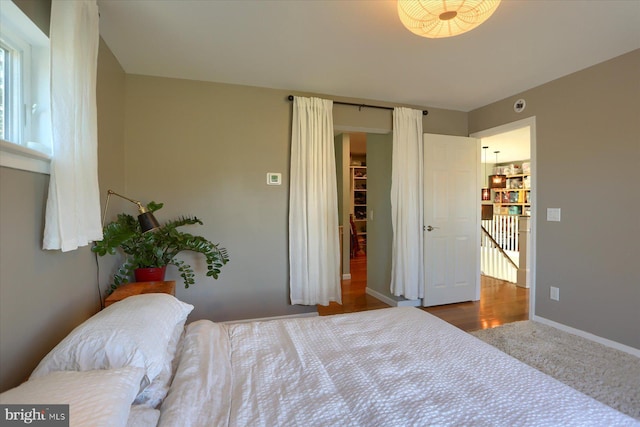 bedroom featuring carpet floors and baseboards