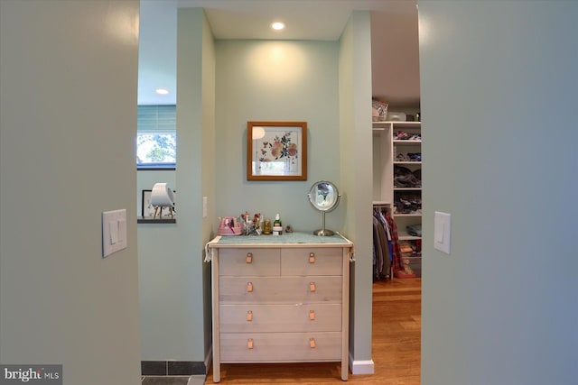 hallway featuring wood finished floors and recessed lighting