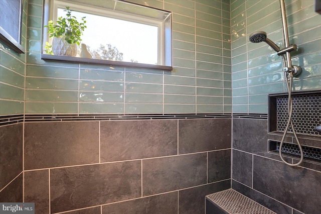 bathroom with a tile shower