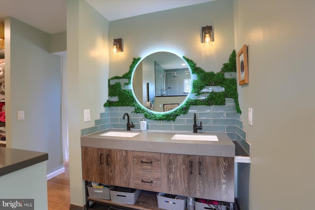 full bathroom featuring double vanity, tasteful backsplash, a shower, and a sink