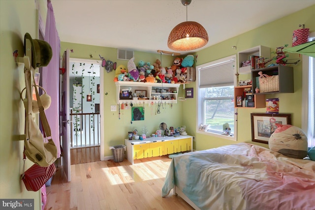 bedroom with visible vents and wood finished floors