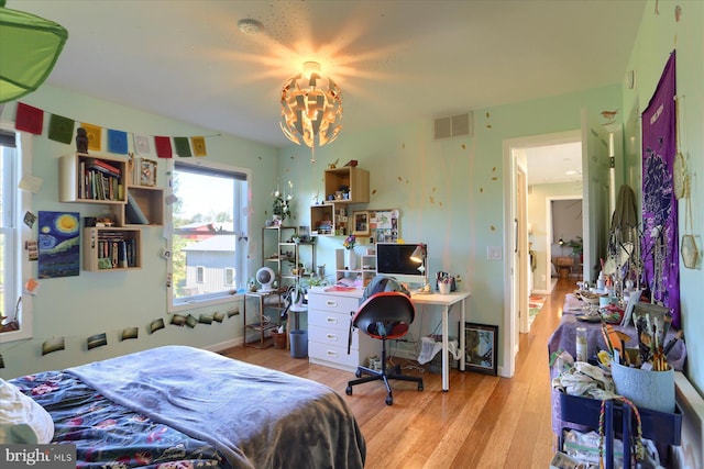 bedroom featuring visible vents and wood finished floors