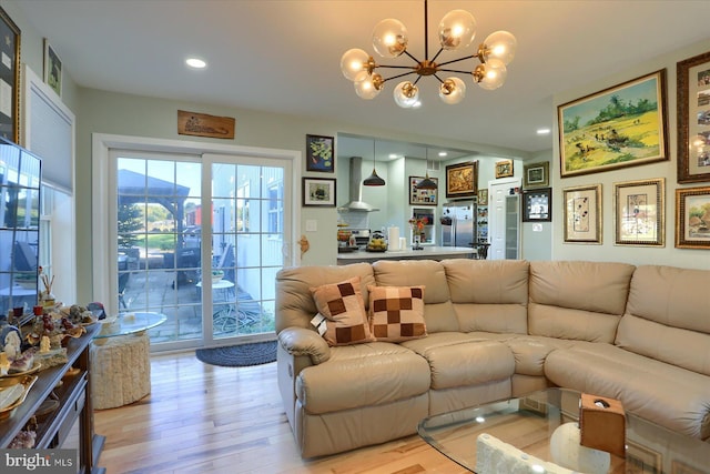 living room featuring a chandelier, recessed lighting, and light wood-style floors