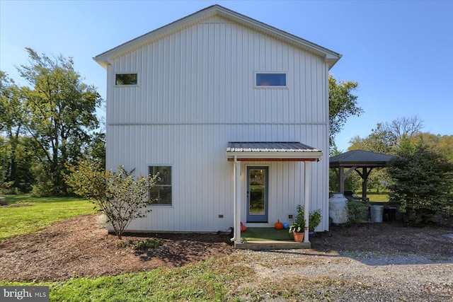 view of front of house featuring metal roof and a gazebo