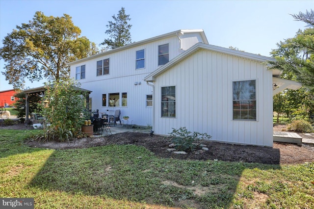 back of property featuring a yard and a patio