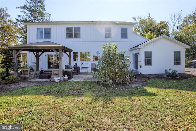 back of property featuring a gazebo, a lawn, and a patio area