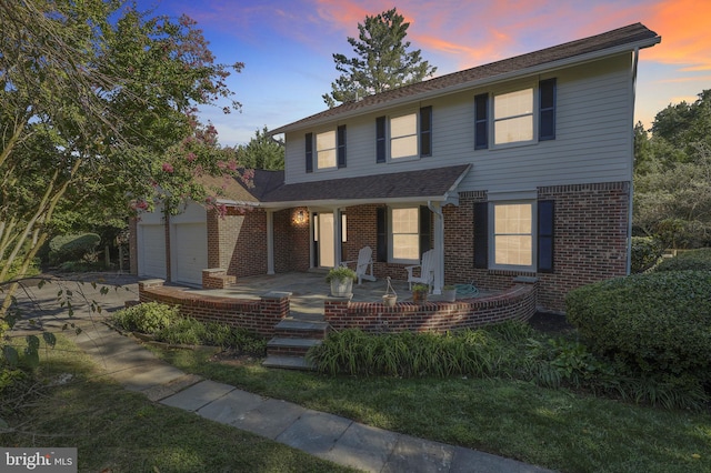 view of front of property featuring a garage and covered porch