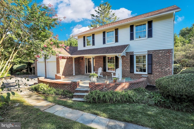 view of front of house featuring covered porch and a garage