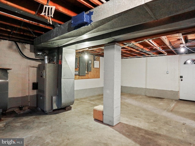 unfinished basement featuring heating unit and electric panel