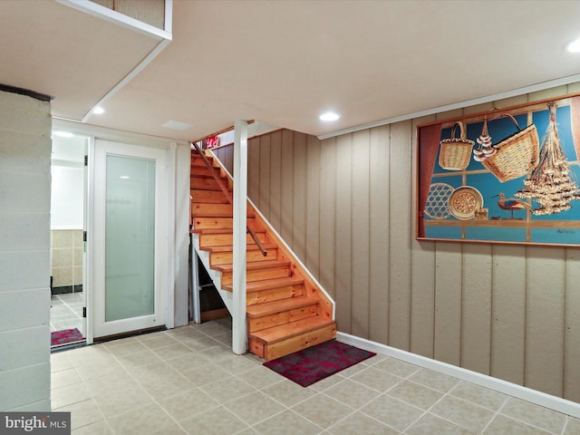 finished below grade area featuring stairway and recessed lighting