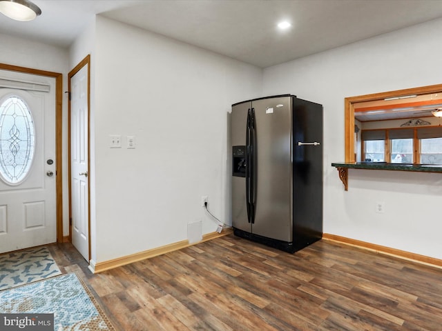 entryway featuring dark wood-style flooring and baseboards