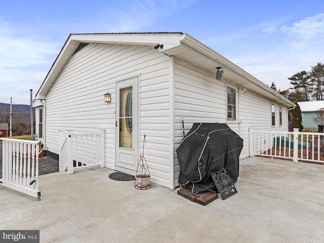 rear view of house with a patio area and fence