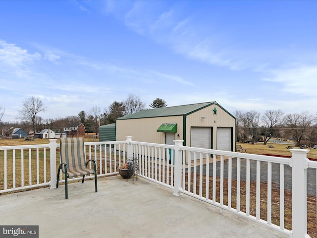 view of patio with a garage and an outdoor structure