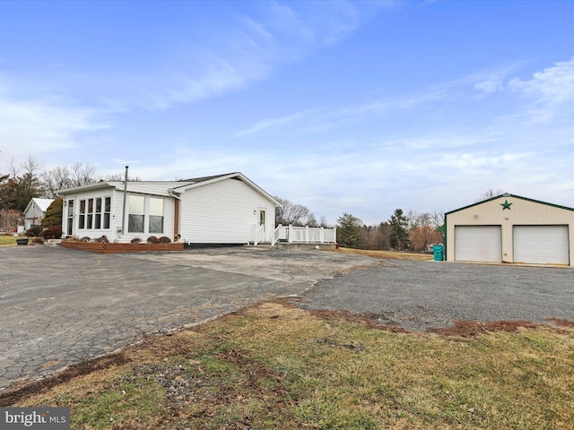 view of home's exterior with a garage and an outdoor structure