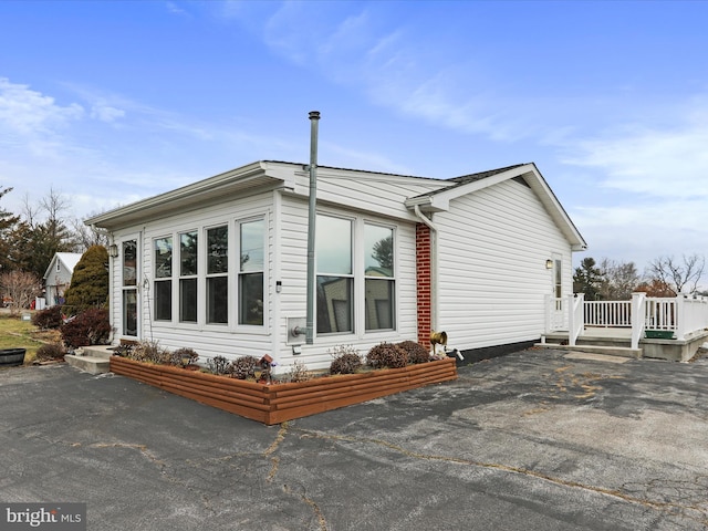 view of home's exterior with aphalt driveway