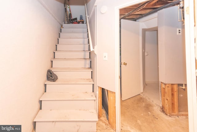 stairs with concrete flooring