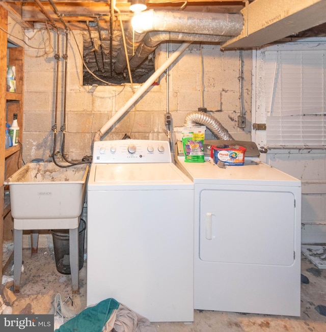 clothes washing area with sink and washing machine and clothes dryer