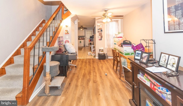 office with light hardwood / wood-style floors and ceiling fan