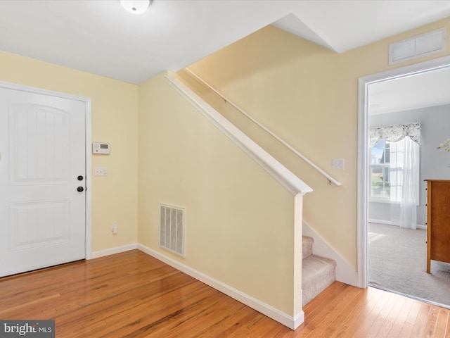 entryway with hardwood / wood-style floors