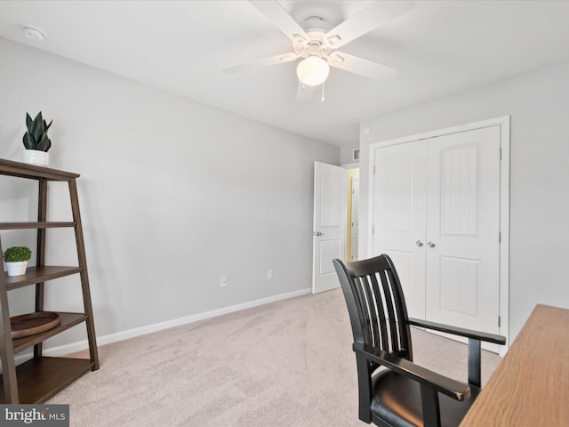 carpeted office featuring ceiling fan