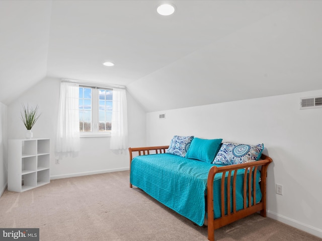 carpeted bedroom with lofted ceiling